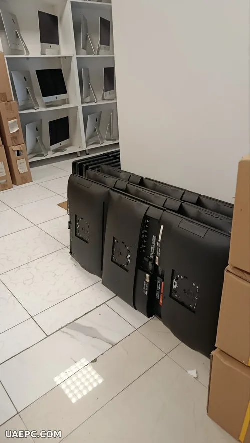 Second-hand all-in-one PCs stacked for a bulk order — B2B wholesale, Sharjah UAE