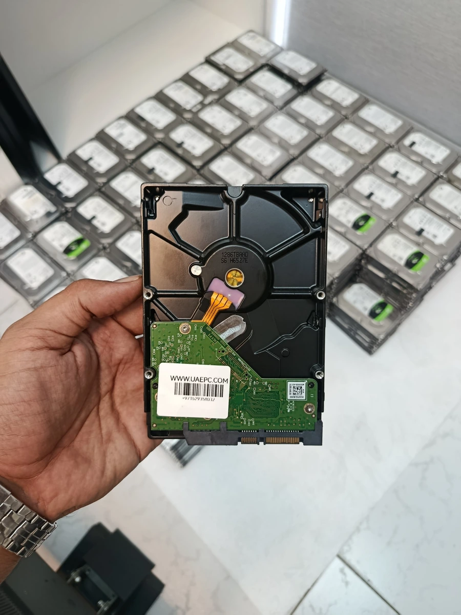 3.5-inch used hard drive with UAEPC.COM label held in hand, Sharjah warehouse
