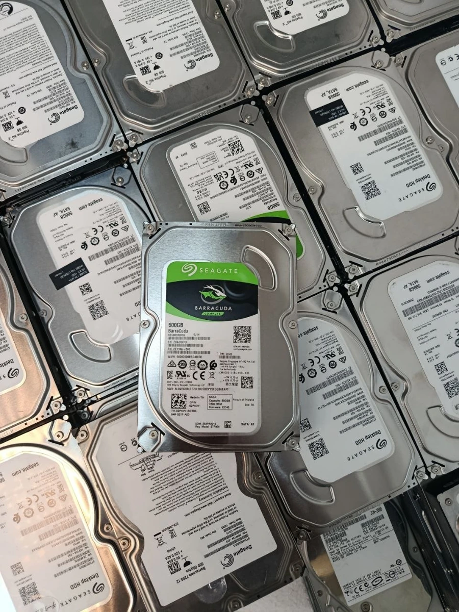 Seagate BarraCuda 500GB drive on stacks of used hard drives at UAEPC warehouse